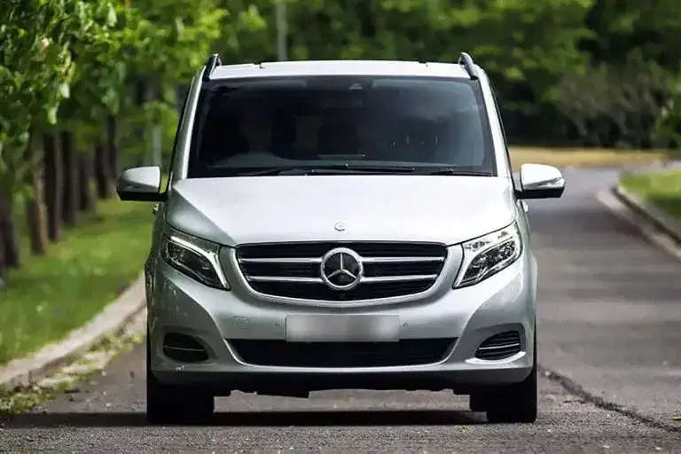 A luxury Tranzcare executive Mercedes Sprinter support vehicle stationed on a media production set near MediaCityUK. A line-up of premium Tranzcare chauffeured MPVs and crew sprinters ready for multi-location television production movements.