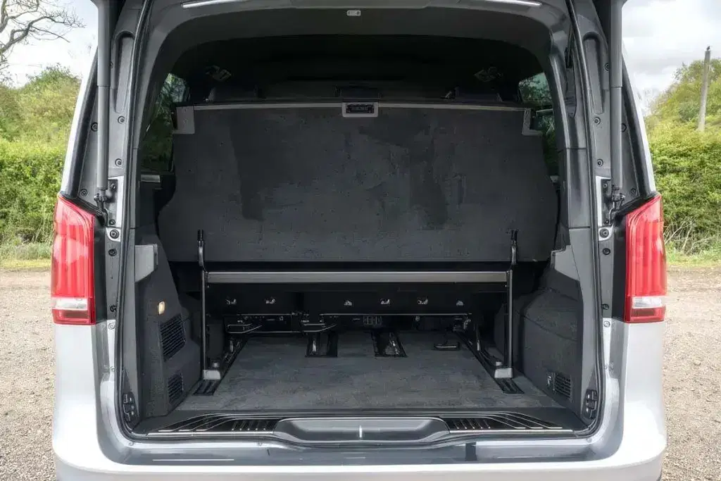 Deep rear luggage boot of a Tranzcare Mercedes V-Class chauffeur vehicle open to show extensive capacity for premium airport transfer suitcases.