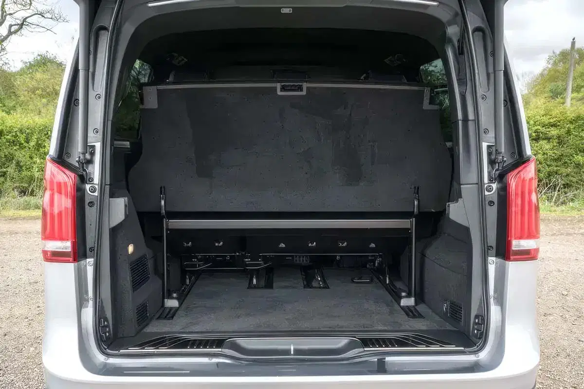 Deep rear luggage boot of a Tranzcare Mercedes V-Class chauffeur vehicle open to show extensive capacity for premium airport transfer suitcases.