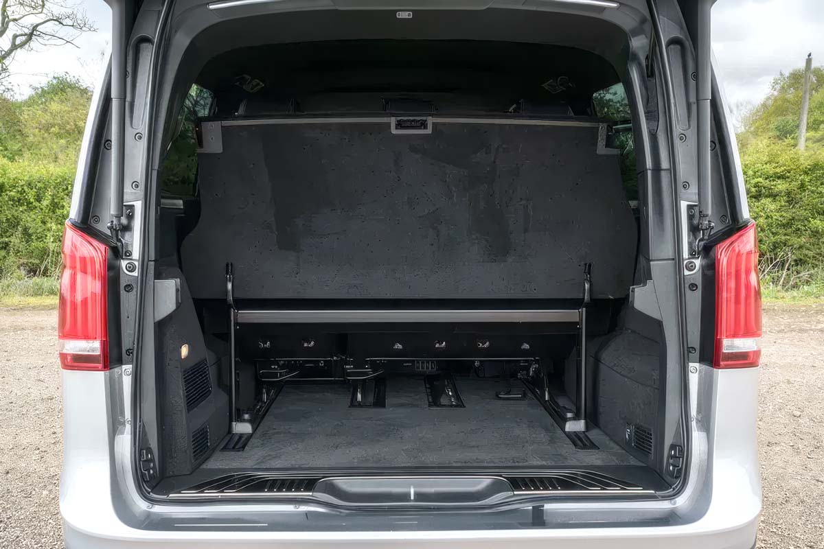 Deep rear luggage boot of a Tranzcare Mercedes V-Class chauffeur vehicle open to show extensive capacity for premium airport transfer suitcases.